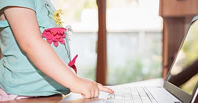 small child using laptop